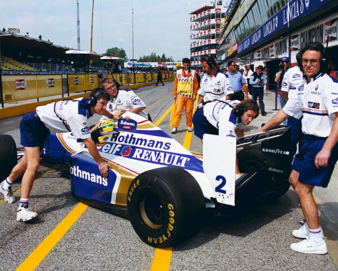 williams mechanics bringing ayrton senna's single-seater into the pit