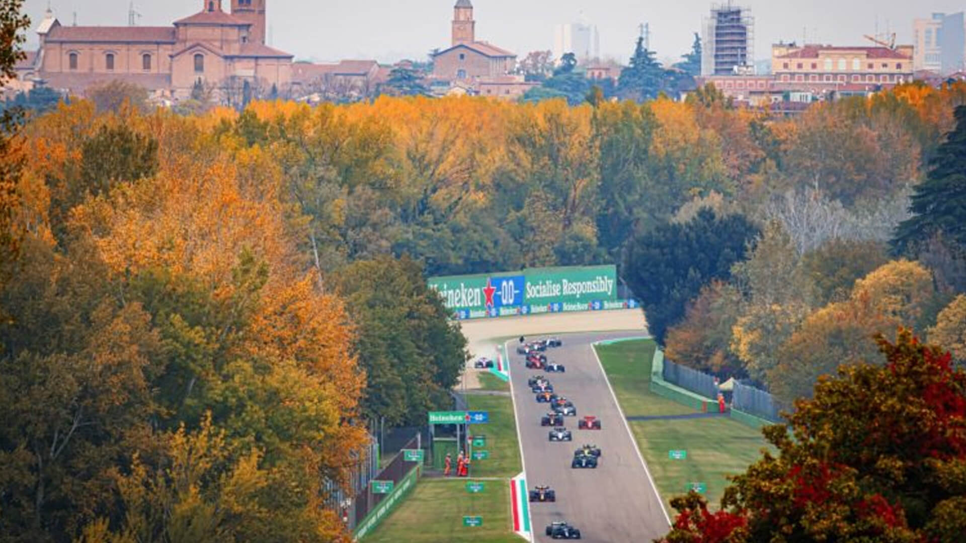 Aerial view of formula one cars speeding inside the imola circuit