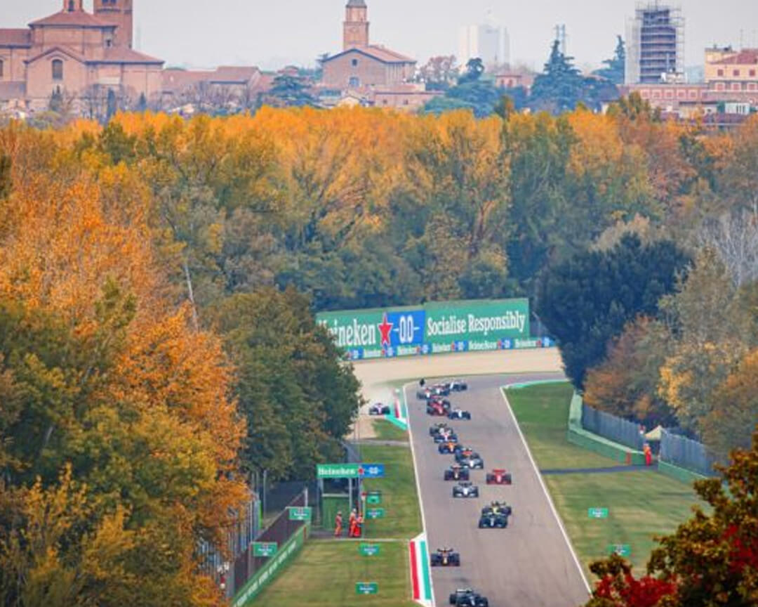 Aerial view of formula one cars speeding inside the imola circuit