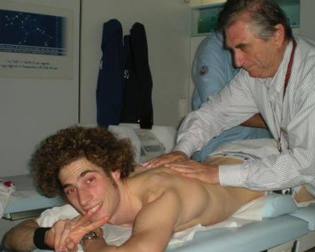 Dr Costa massaging the back of Marco Simoncelli inside the mobile clinic