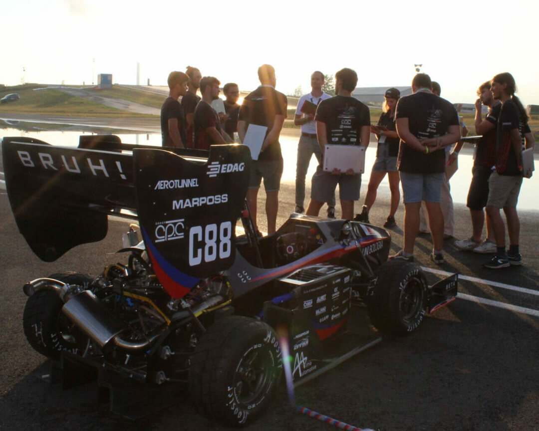 Prototype of a single-seater car with group of students on test circuit