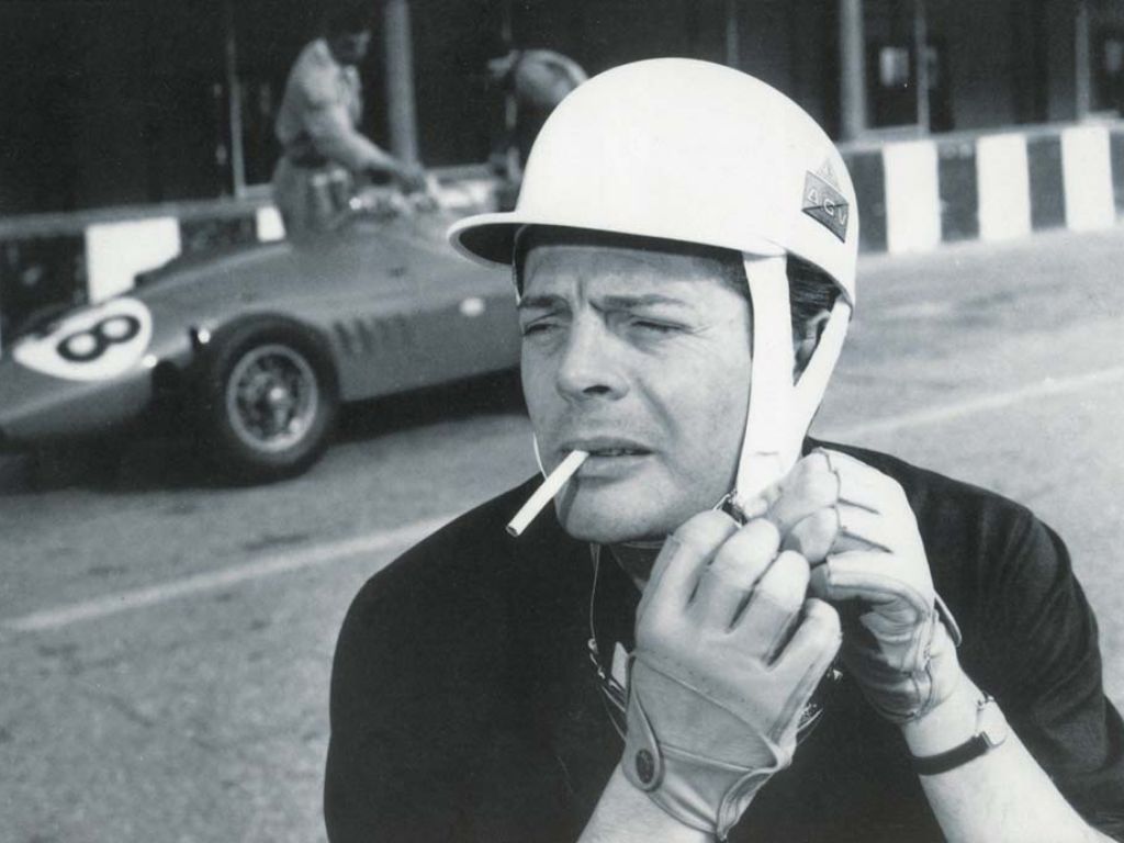 Marcello Mastroianni si allaccia il caso in pista con alle spalle una Stanguellini.