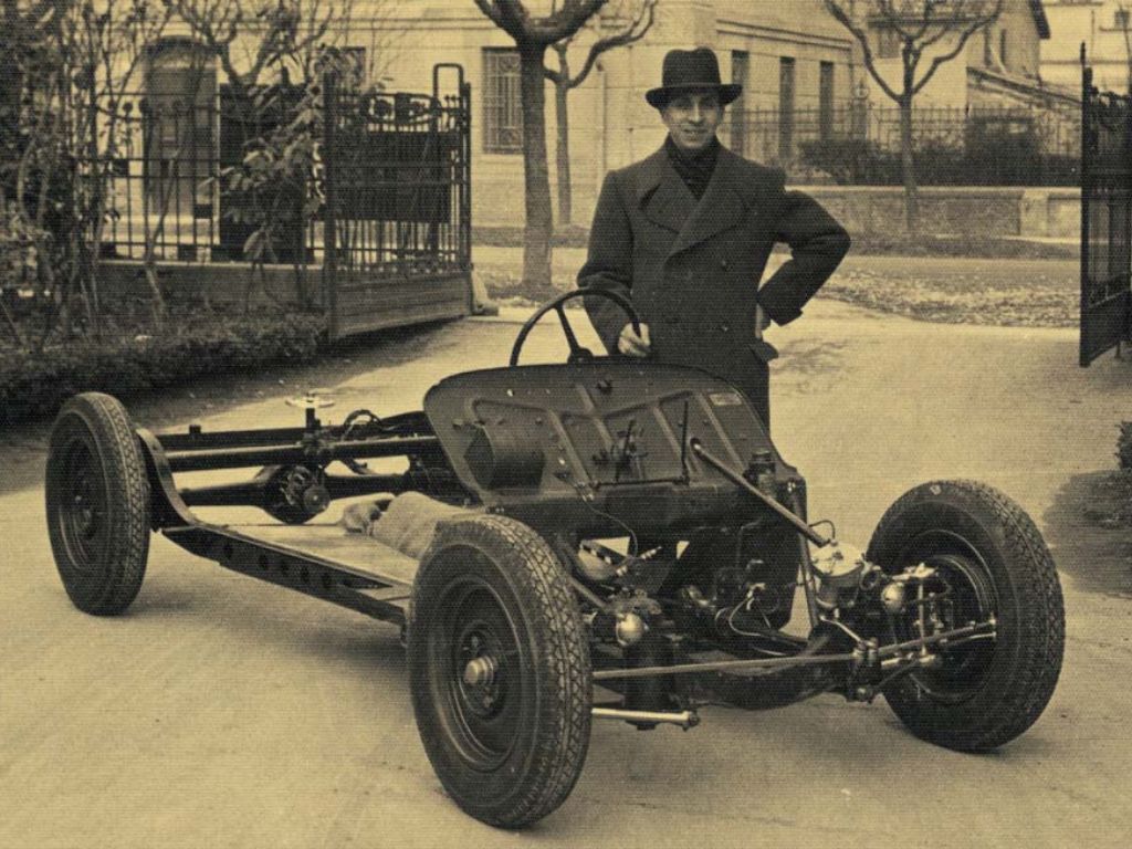 Vittorio Stanguellini in posa con un'auto d'epoca.