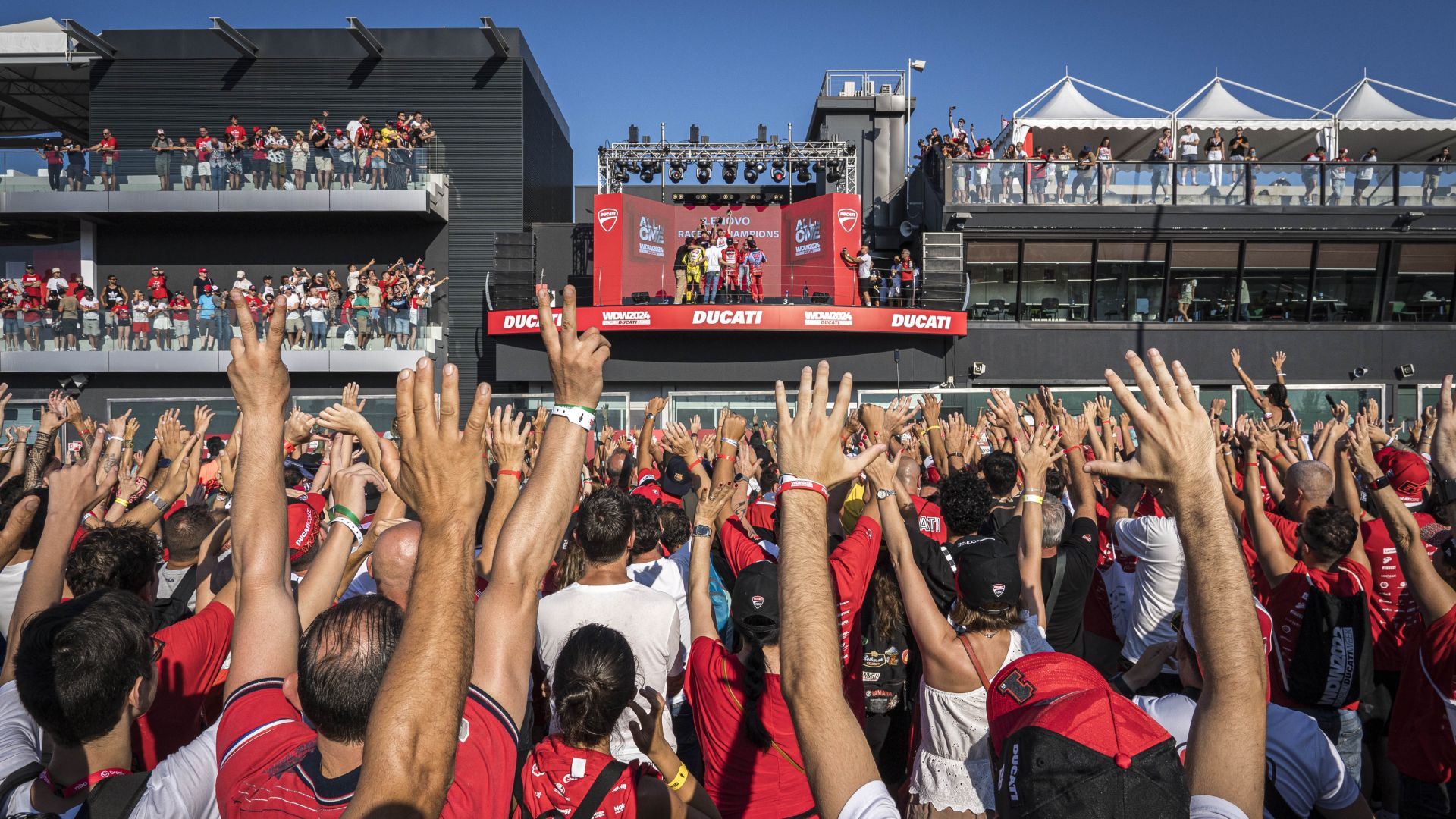 La folla alza le mani sotto il palco del World Ducati Week a Misano.
