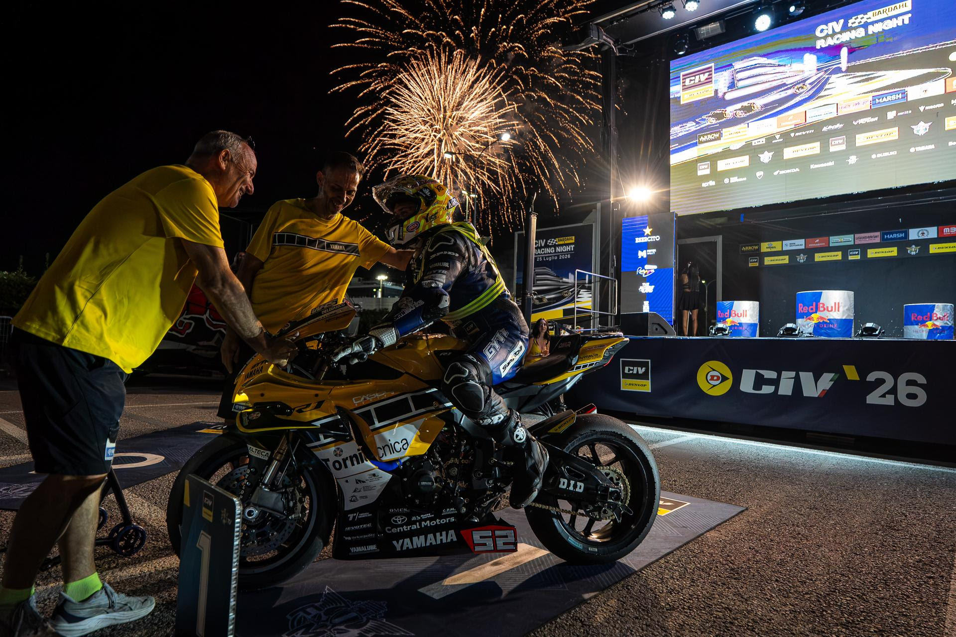 Una moto della CIV Racing Night a Misano con i fuochi d'artificio sullo sfondo.